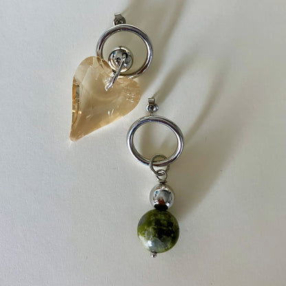 Earrings with heart-shaped and round bead designs on a white background